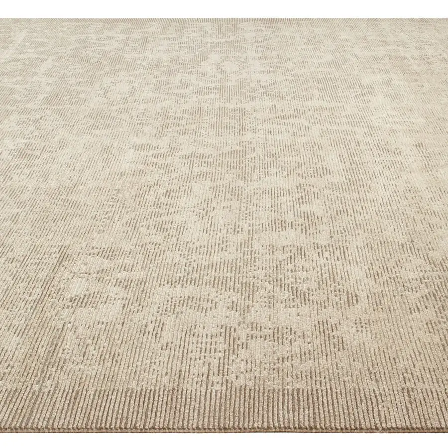 Distinguished Amini Mystique rug hand-knotted in Nepal with a subtly distressed neutral beige palette and silk wool pile finish