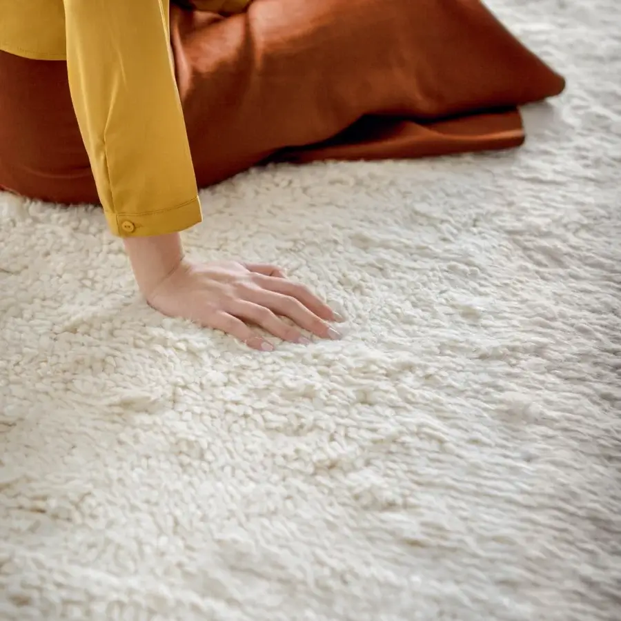 Distinguished Amini Nomadic rug hand-knotted in India with wool and mohair exhibiting a subtly textured off-white surface and carved finish