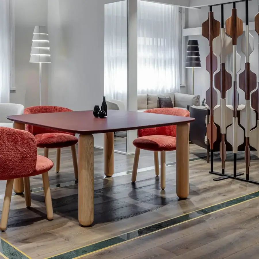 Distinguished Enrico Pellizzoni Isabel chair with reddish-orange bouclé textile upholstery and natural ash turned legs
