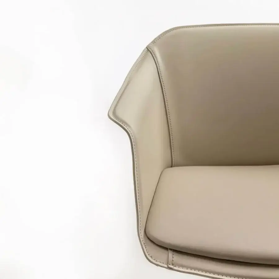 Elegant Enrico Pellizzoni Eva armchair with curved silhouette and smooth matte synthetic upholstery crafted with a 4-star swivel base
