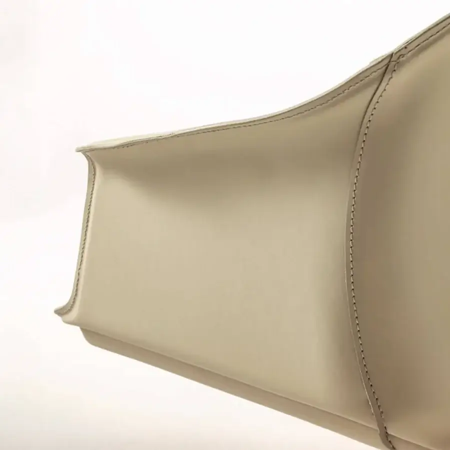 Distinguished Enrico Pellizzoni Eva armchair with gently curved form upholstered in matte neutral beige leather and refined stitched detailing