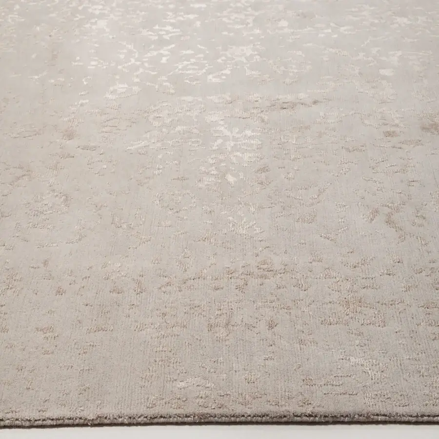 Exquisite Amini Artemisia rug with distressed floral pattern in muted beige wool and viscose, finished with a hand-washed carved technique