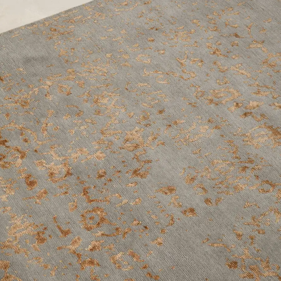 Lavish Amini Artemisia rug hand-knotted in India with wool and viscose, displaying abstract patterns in muted grey and golden-brown tones with a carved finish