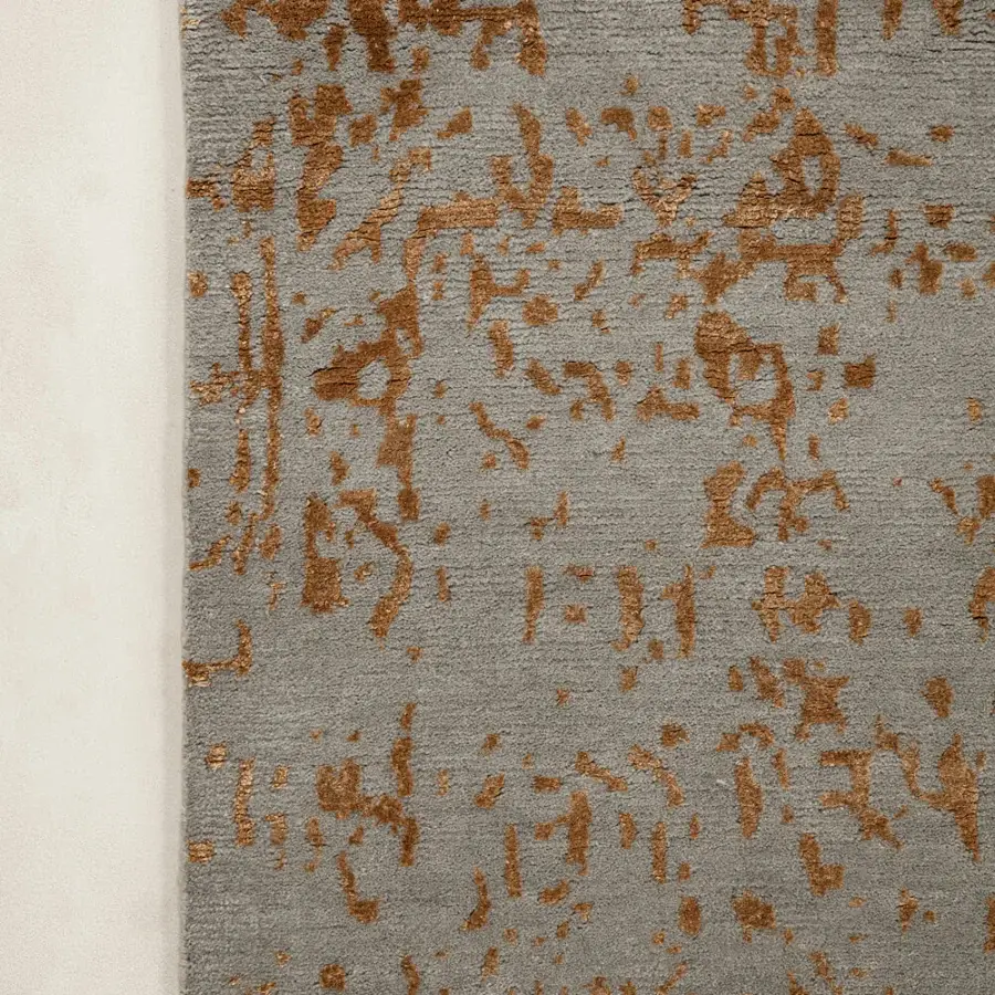 Exceptional Amini Artemisia rug hand-knotted in India with wool and viscose, showcasing abstract expressionist style in muted grey and golden-brown hues with a carved finish