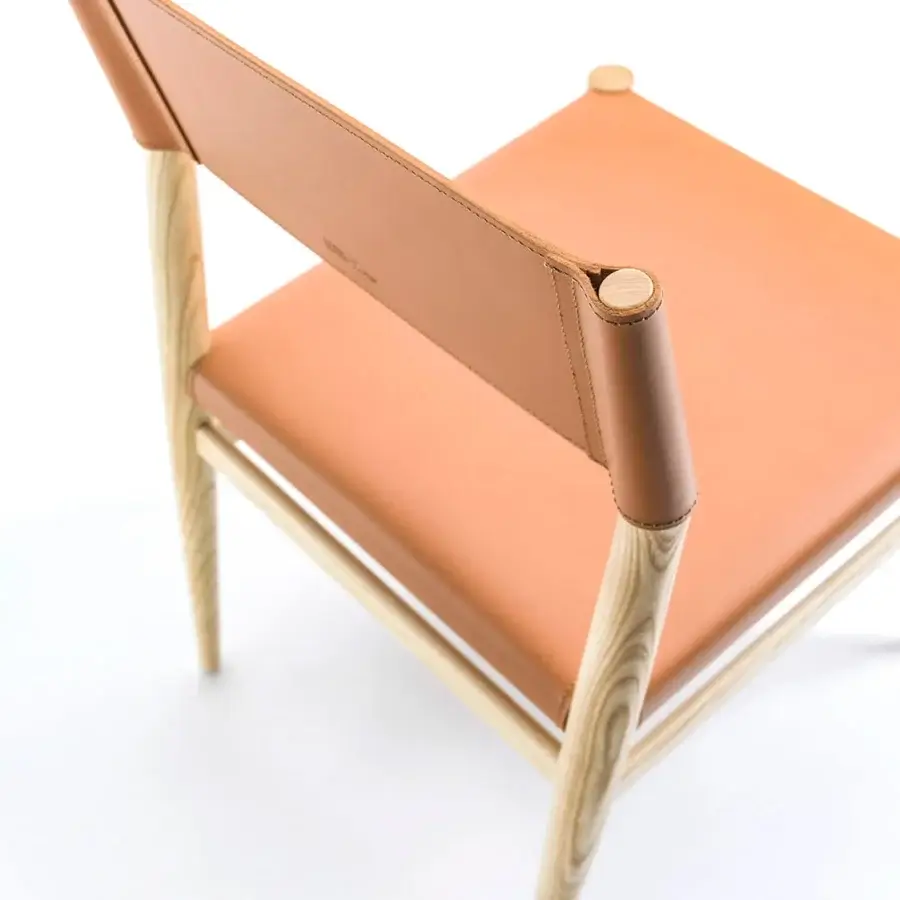 Distinguished Enrico Pellizzoni Ledermann chair built with orange-brown leather and light-toned wood, showcasing conical legs and straps