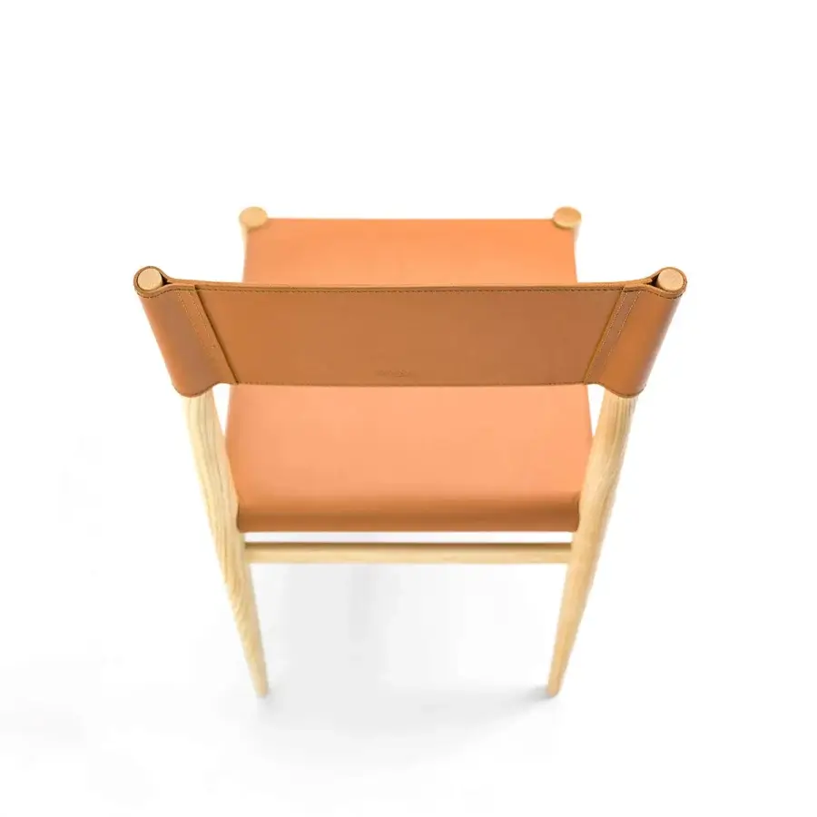 Superior Enrico Pellizzoni Ledermann chair built with warm orange-brown leather and a black technical fabric base with wood frame