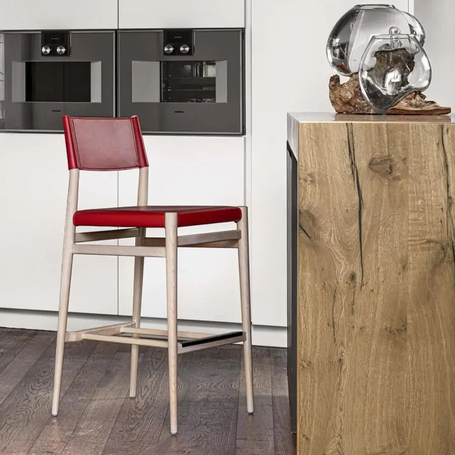 Lavish Enrico Pellizzoni Ledermann counter stool with red leather upholstery and satin-finish wooden conical legs