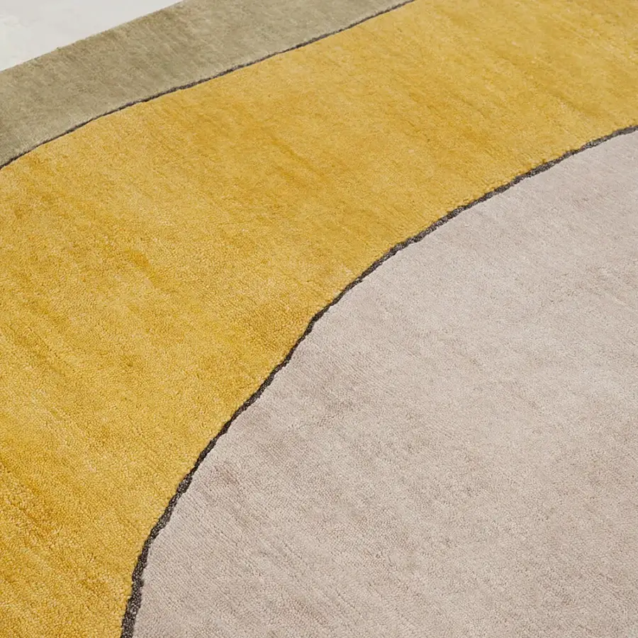 Lavish Amini Ritagli bamboo silk rug with abstract geometric shapes outlined in mustard yellow, pale grey, and charcoal hues crafted in India