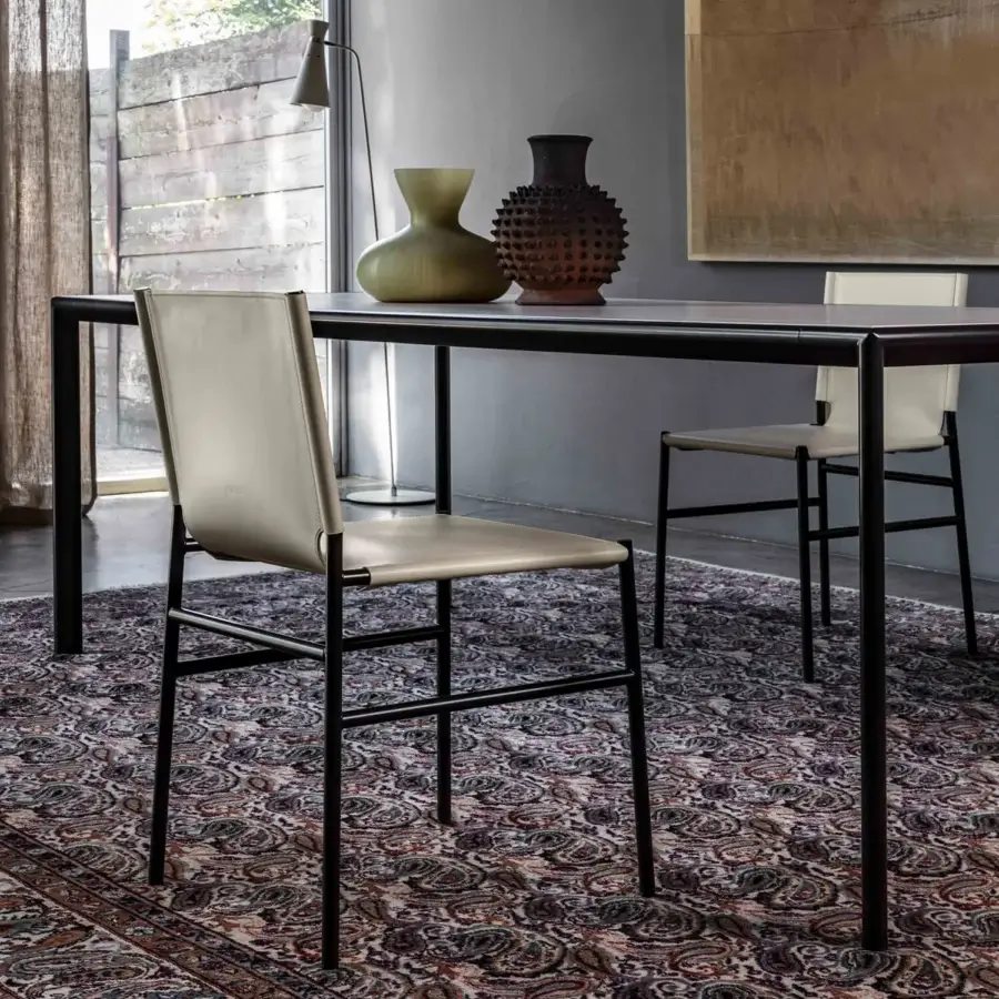 Distinguished Enrico Pellizzoni Elena chair with slender matte black tubular metal and pale grey leather upholstery