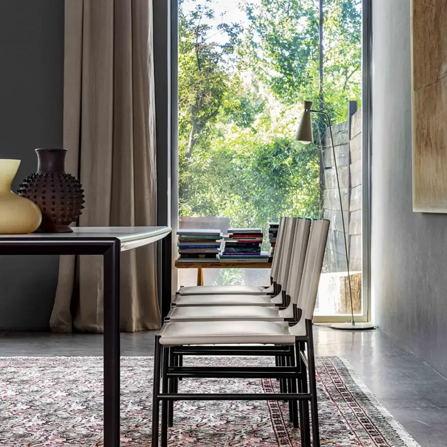 Elegant Enrico Pellizzoni Elena chair crafted with slender matte dark gray tubular metal and smooth light neutral textile upholstery
