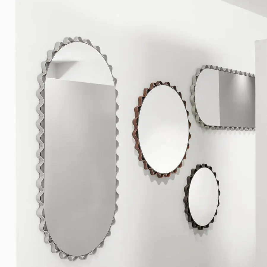 Distinguished Enrico Pellizzoni Glimt mirror crafted with a round, wavy frame in supple leather and warm bronze tone