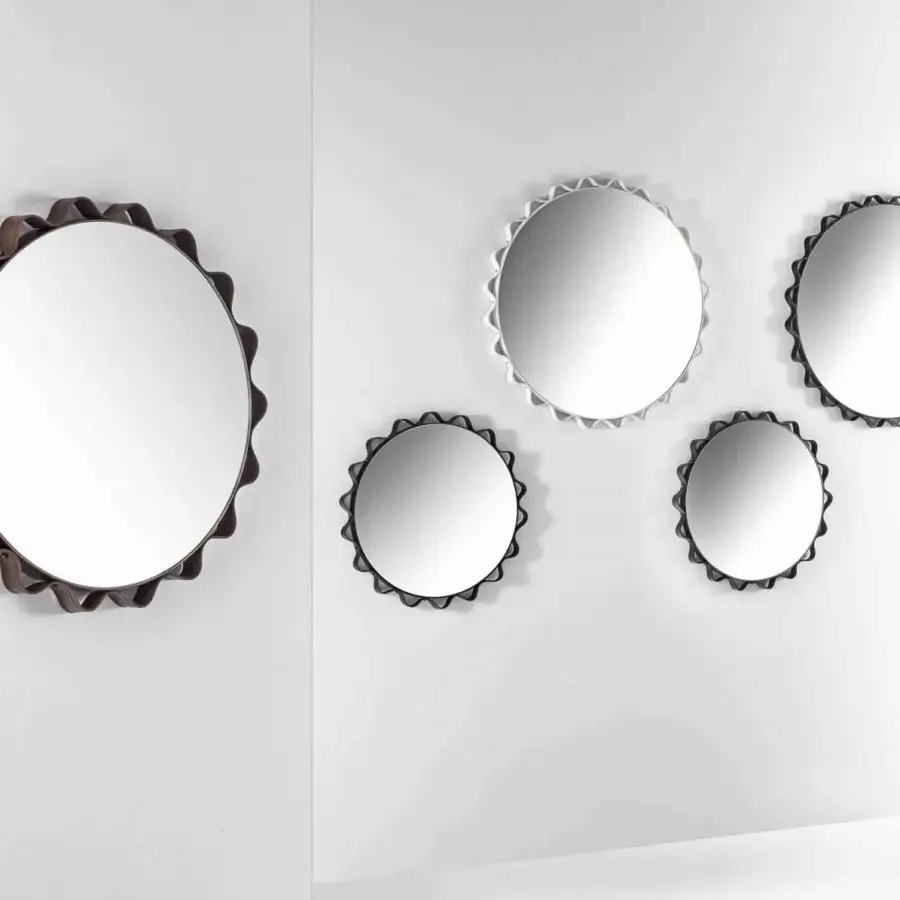 Lavish Enrico Pellizzoni Glimt mirror crafted with a round, wavy frame in matte dark brown leather and bright brass studs