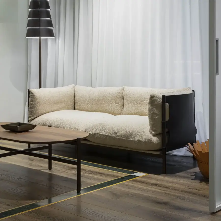 Distinguished Enrico Pellizzoni Iris sofa with dynamic metal support and heavily textured off-white looped-pile textile detailing