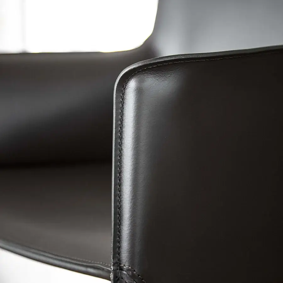 Refined Enrico Pellizzoni Pasqualina armchair with fully leather-covered structure and matte black finish showcasing skilled visible stitching