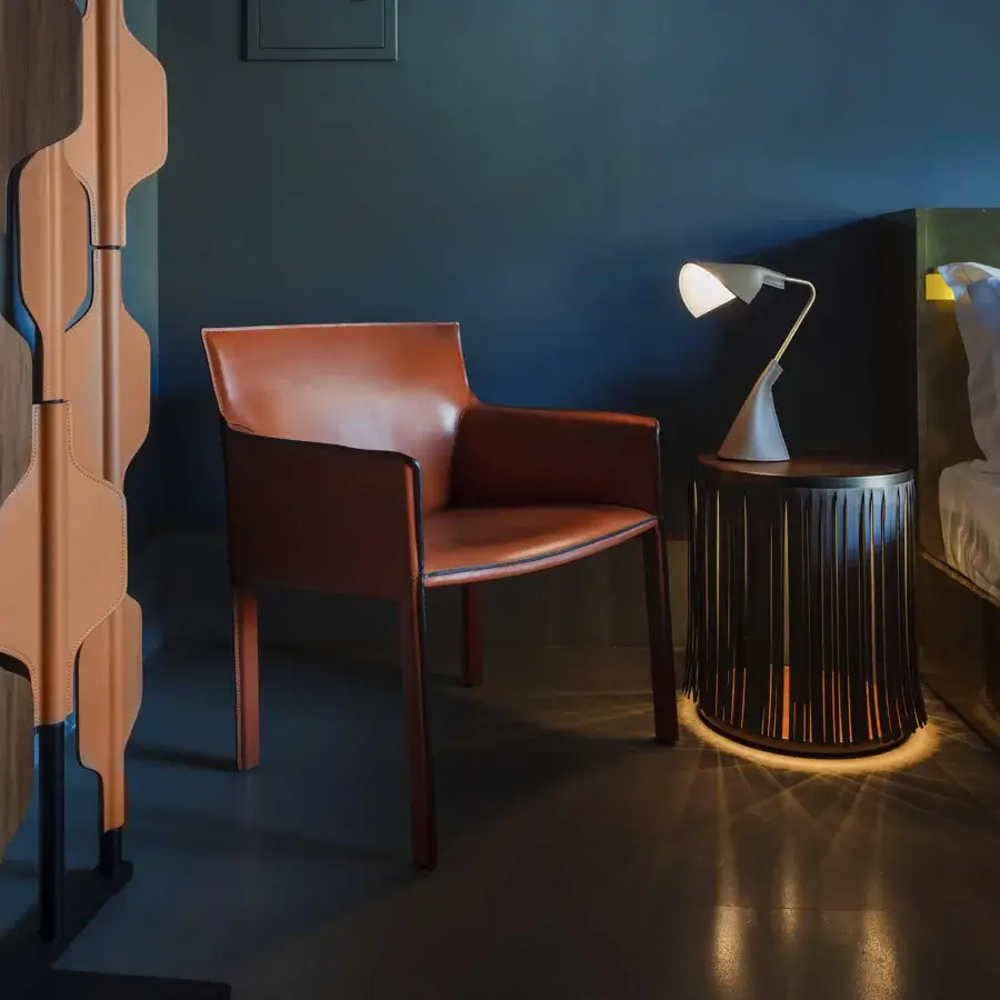 Exceptional Enrico Pellizzoni Pasqualina lounge chair with reddish-brown leather upholstery and satin finish crafted in dark-toned wood