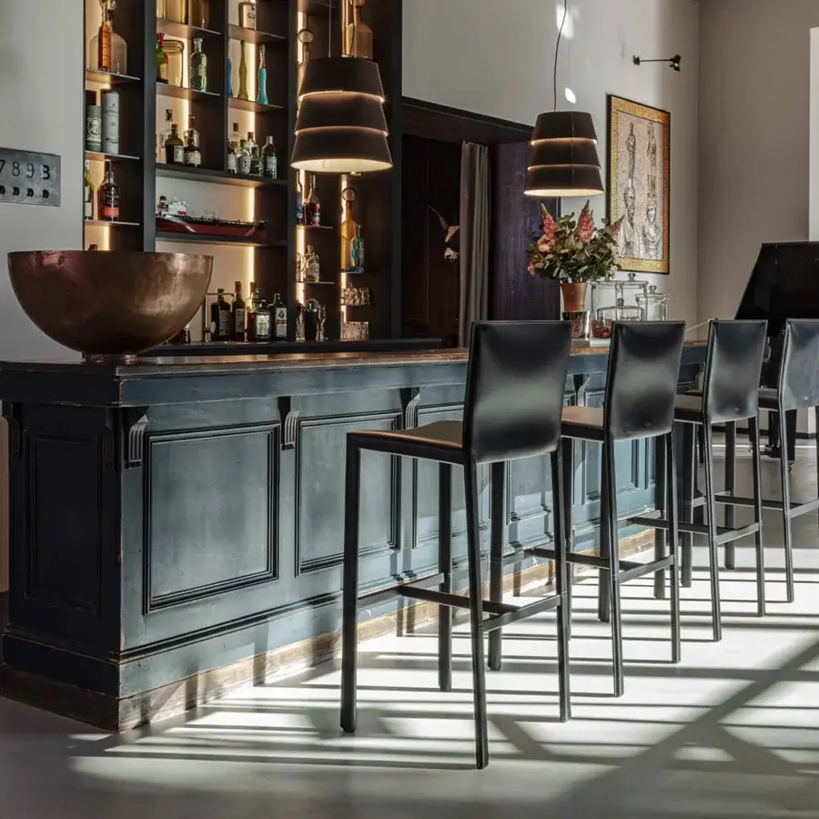 Exceptional Enrico Pellizzoni Pasqualina counter stool with leather frame and seat, showcasing meticulous fabrication with exposed stitching in black or charcoal gray