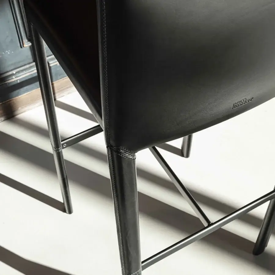 Superior Enrico Pellizzoni Pasqualina counter stool built in black leather with exposed stitching and sleek metal frame