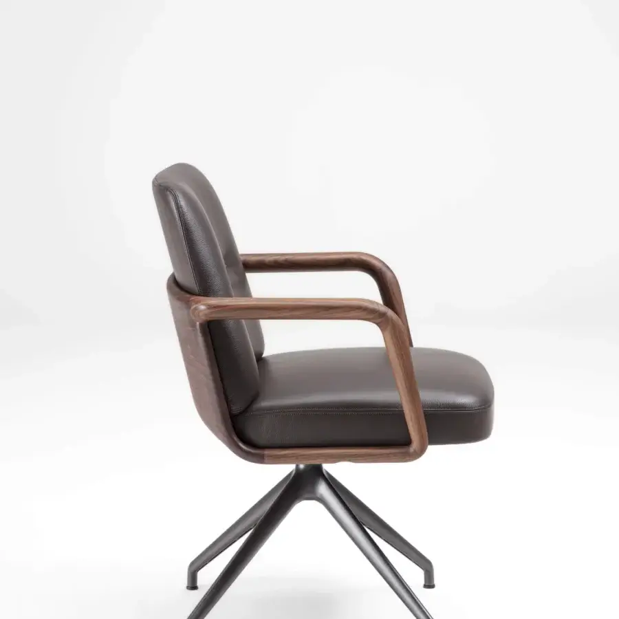 Exceptional Porada Cuna swivel chair crafted with sculpted Canaletta walnut and smooth dark textile upholstery in matte dark metal