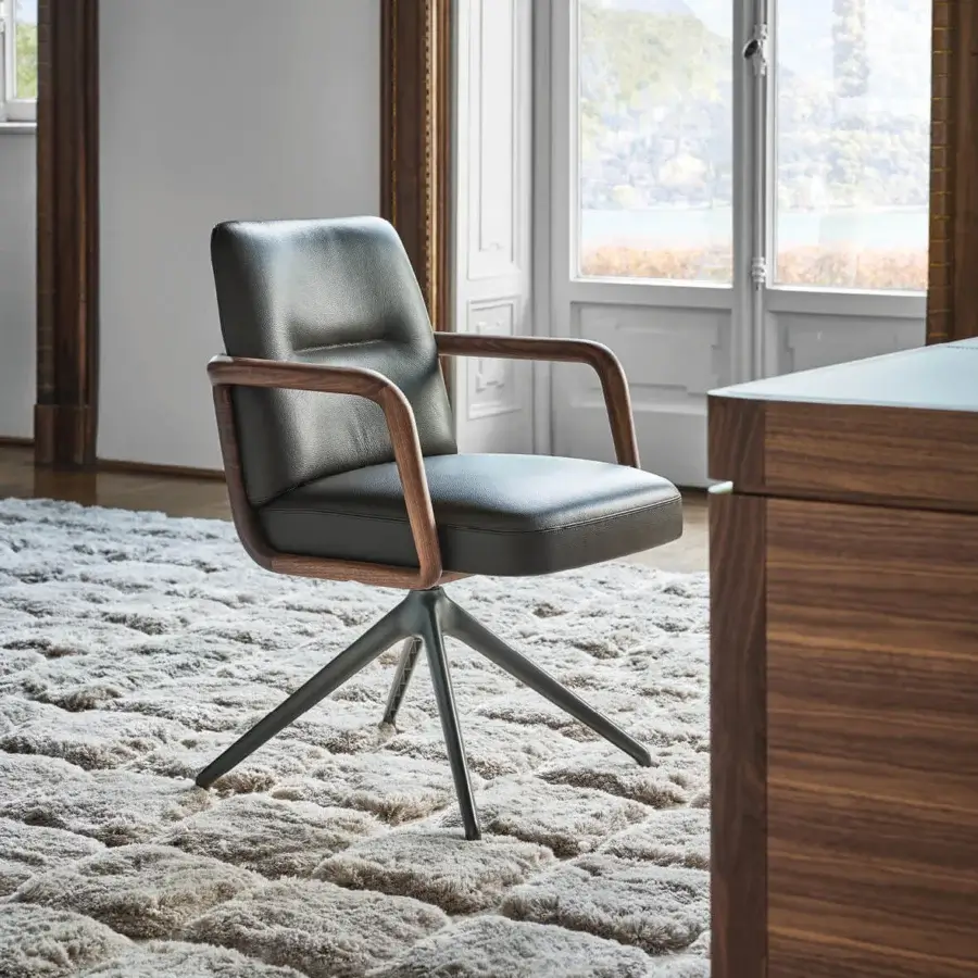 Distinguished Porada Cuna swivel chair with sculpted Canaletta walnut frame and dark gray textured upholstery in satin finish