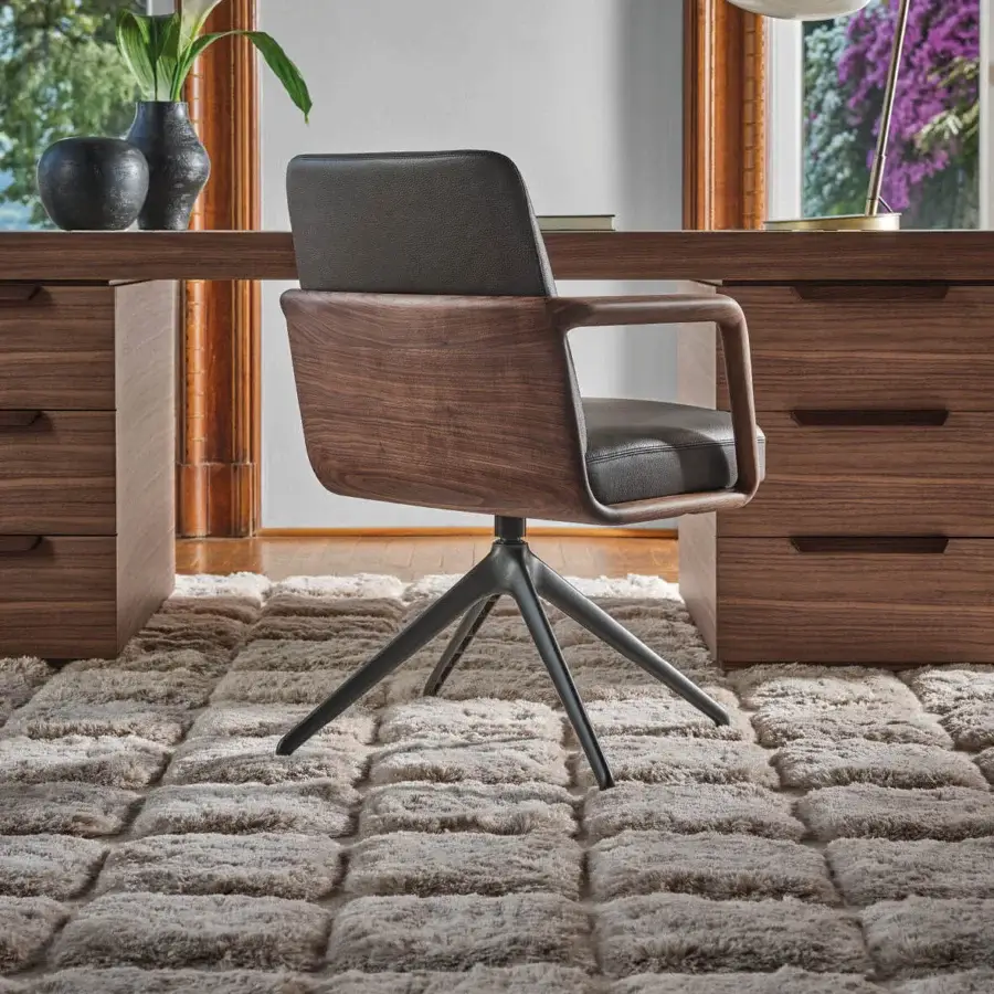 Sophisticated Porada Cuna swivel chair crafted with sculpted Canaletta walnut and dark gray upholstery in a satin finish