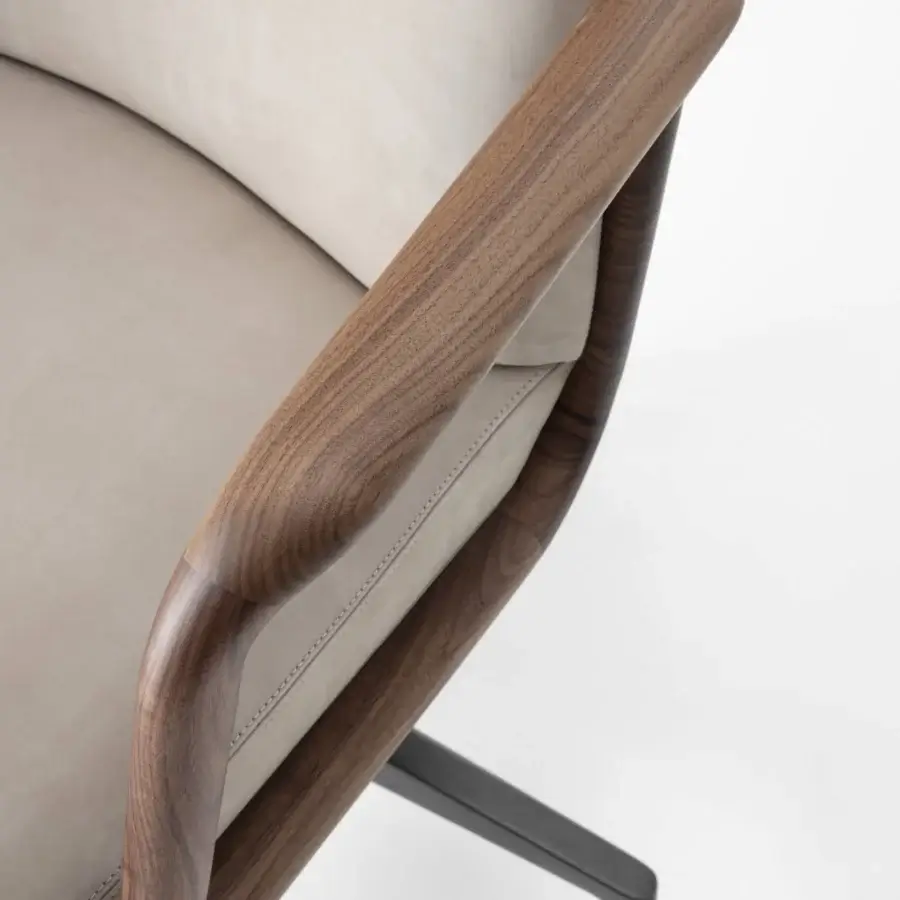 Exceptional Porada Cuna swivel chair crafted with sculpted solid Canaletta walnut in satin finish and neutral light-gray textile upholstery