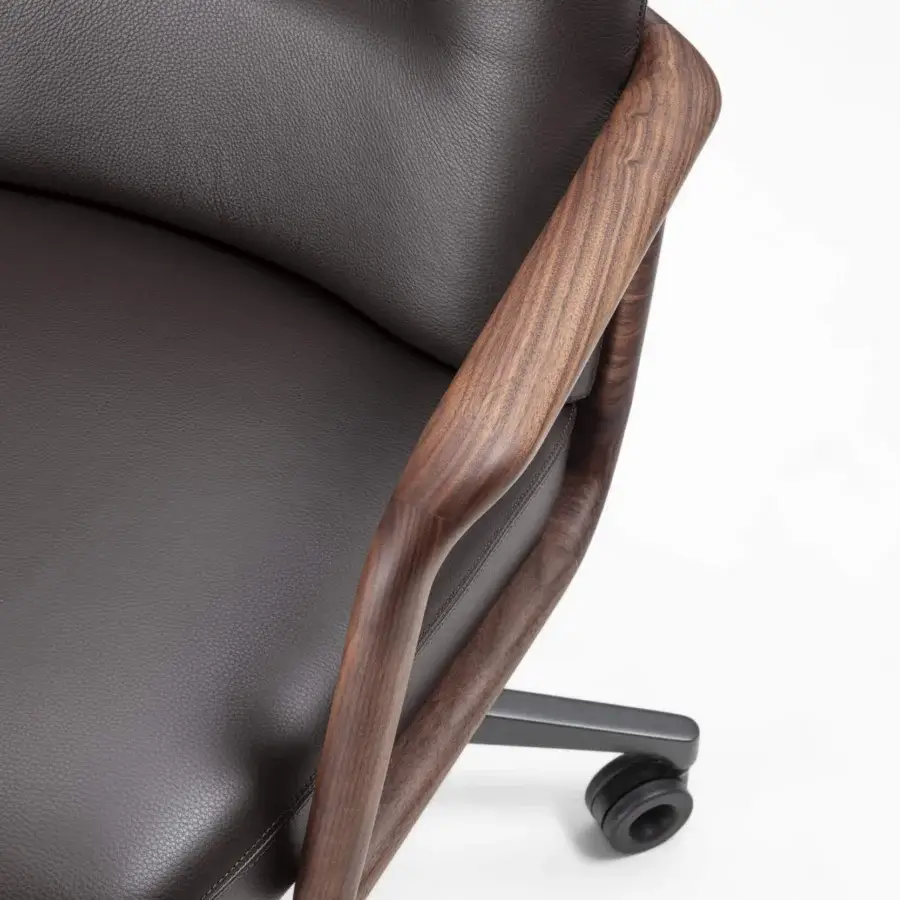 Distinguished Porada Cuna swivel chair with sculpted solid Canaletta walnut and textured dark brown upholstery built with a five-spokes base