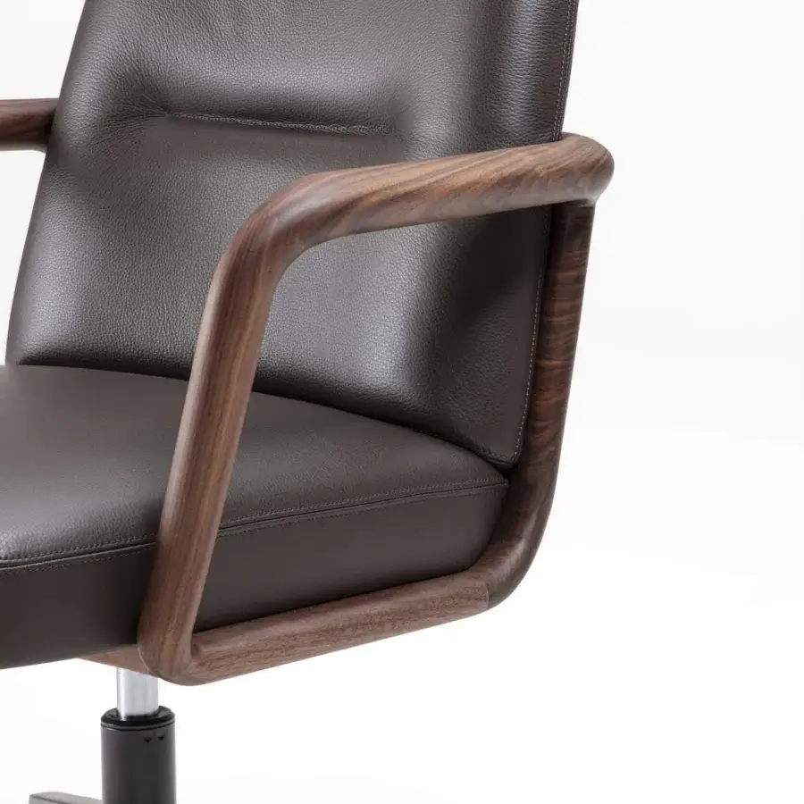 Elegant Porada Cuna swivel chair built with sculpted solid Canaletta walnut in satin finish and dark brown textured synthetic material