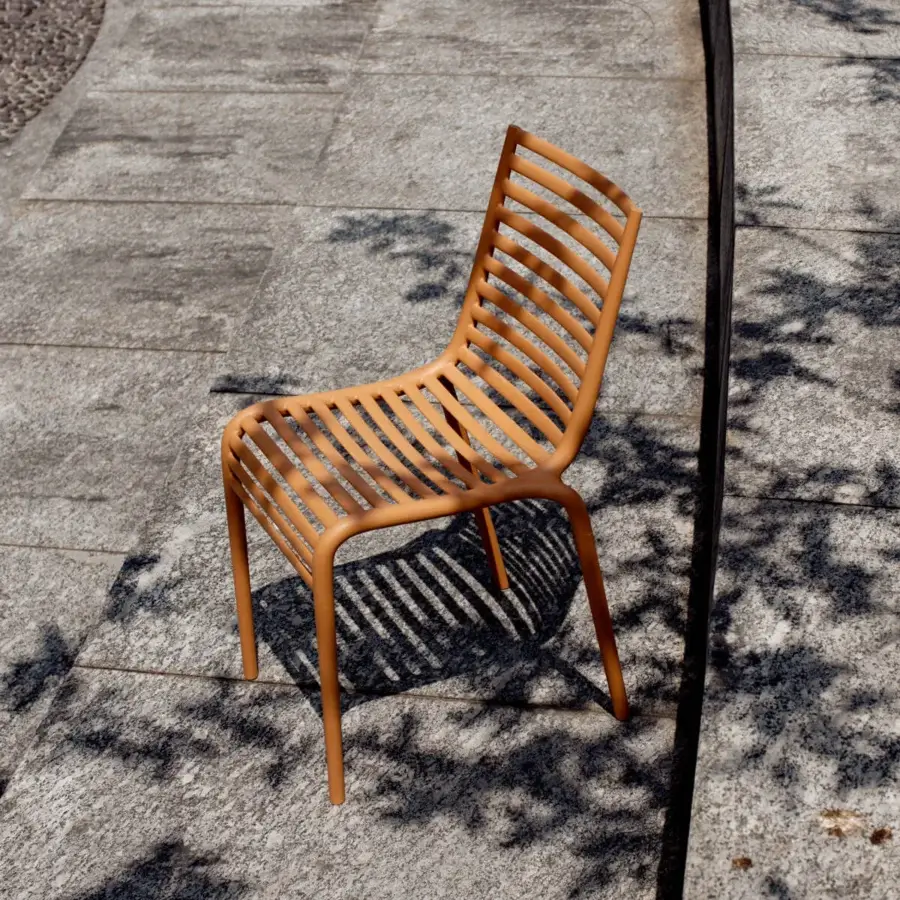 Distinctive Driade Pip-e chair crafted in earthy orange-brown polypropylene with striking horizontal slats offering ergonomic support