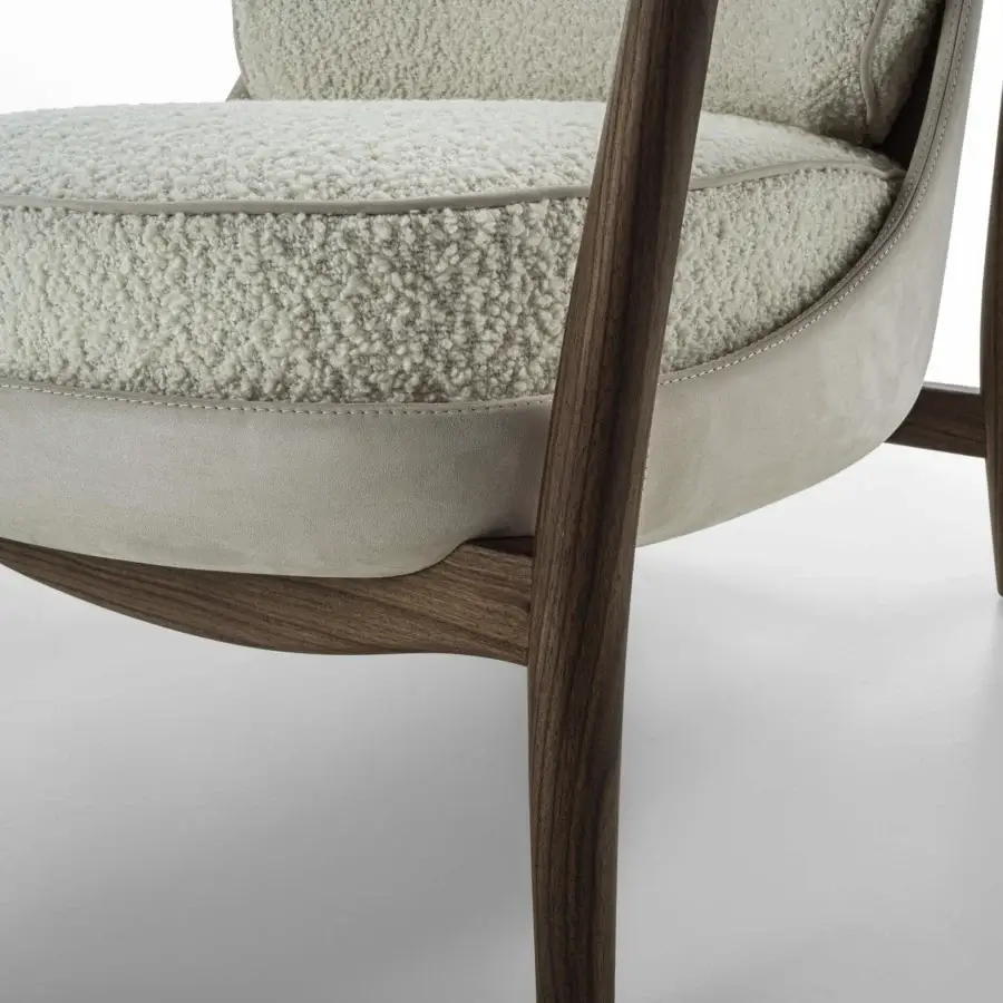 Lavish Porada Ginkgo XL lounge chair with Canaletta walnut frame and supple leather detailing in off-white bouclé-like upholstery