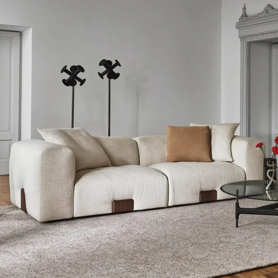 Distinguished Porada Koji sofa upholstered in light beige textured fabric with Canaletta walnut detailing presents a soft rounded form