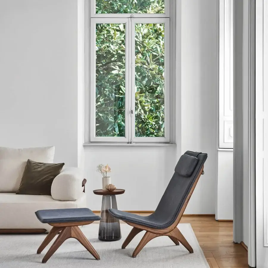 Distinguished Porada Koko lounge chair crafted with Canaletta walnut and dark gray textile upholstery with black chrome detailing