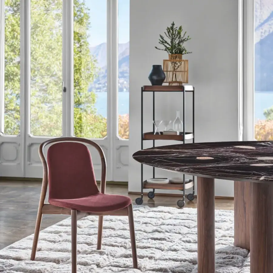 Distinguished Porada Petra chair crafted in solid Canaletta walnut with reddish-brown textile upholstery and a satin finish