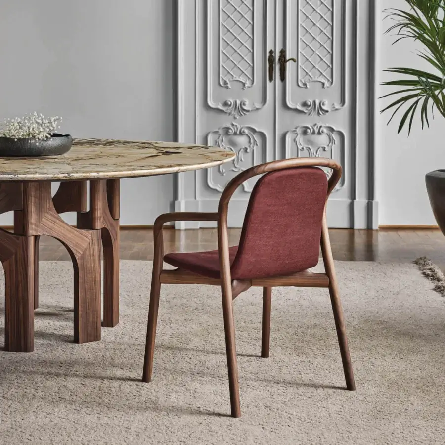 Superior Porada Petra chair built in solid Canaletta walnut with gently arched backrest and reddish-brown textile upholstery with satin finish