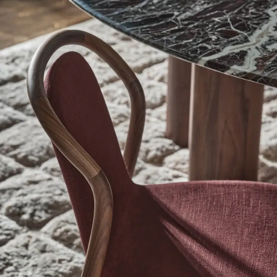 Distinguished Porada Petra chair crafted in solid Canaletta walnut with reddish-brown textured textile and satin finish
