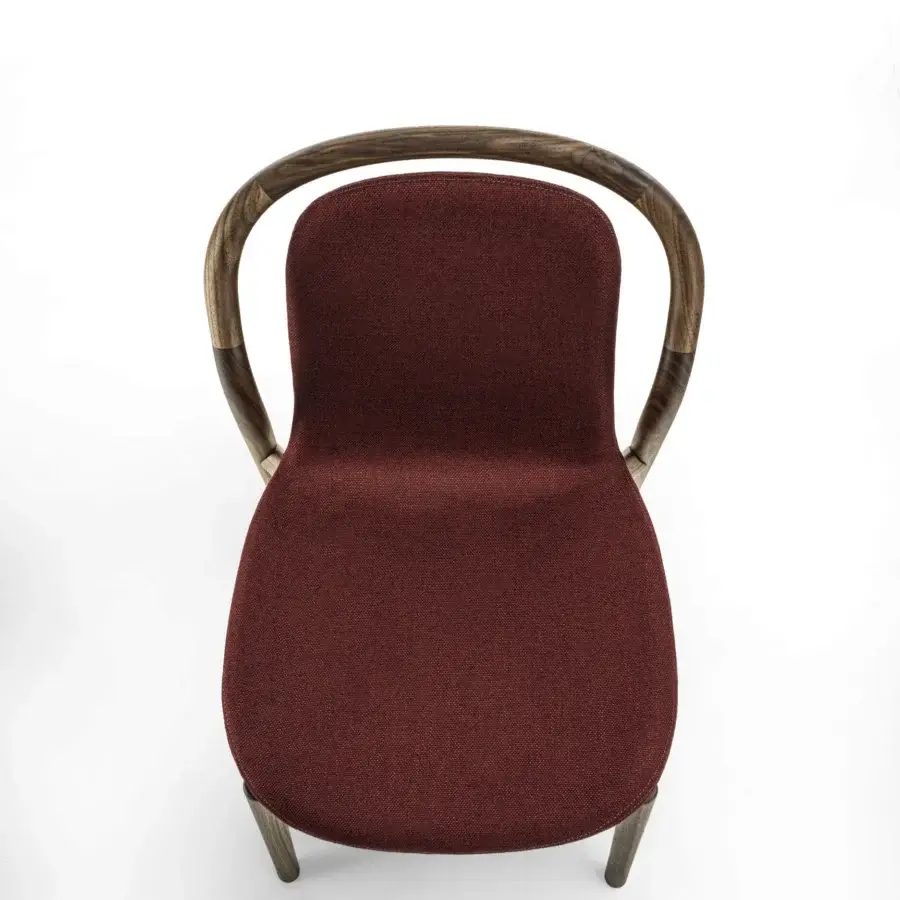 Lavish Porada Petra chair with solid Canaletta walnut frame and subtly flexible deep burgundy textile upholstery