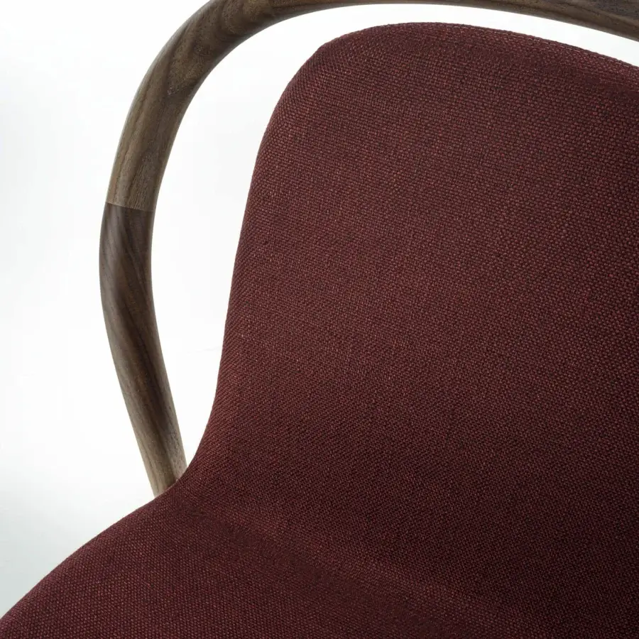 Distinguished Porada Petra chair with solid Canaletta walnut frame and deep burgundy textured textile upholstery