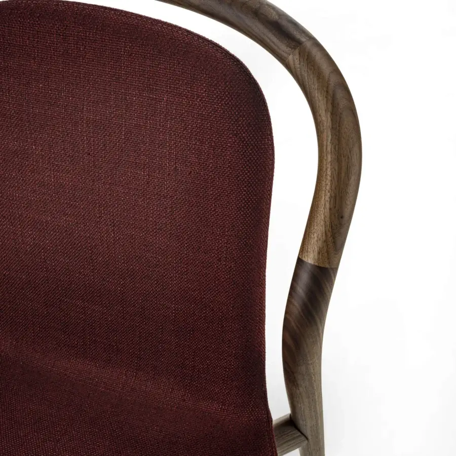 Exceptional Porada Petra chair crafted with solid Canaletta walnut and sumptuous burgundy textile upholstery