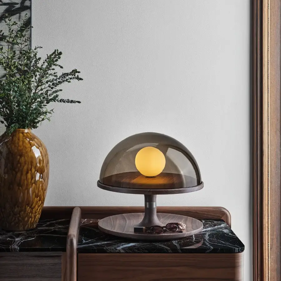 Distinguished Porada Tack table lamp crafted in Canaletta walnut with brushed bronzed brass and a smoked transparent glass diffuser