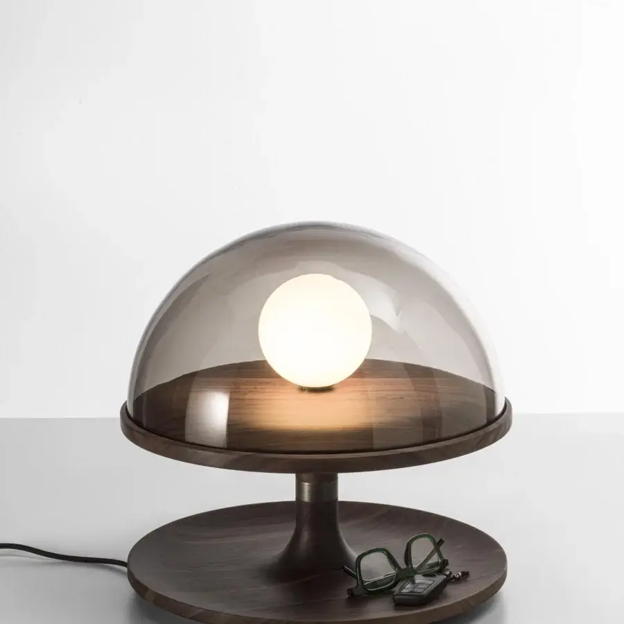 Captivating Porada Tack table lamp crafted in Canaletta walnut with satin finish and bronzed brass accents plus smoked transparent glass diffuser