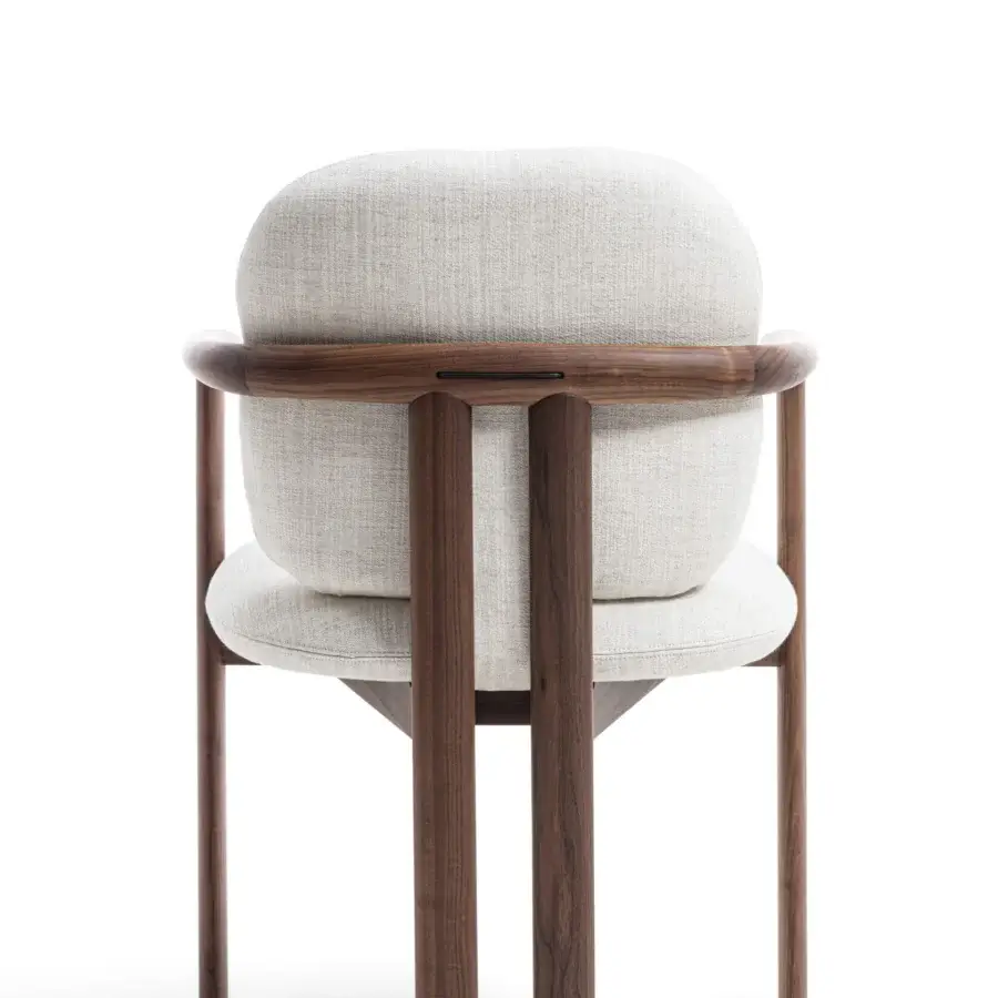 Distinctive Porada Teti chair crafted in solid wood with a satin sheen and neutral textile upholstery secured with saddle leather cord