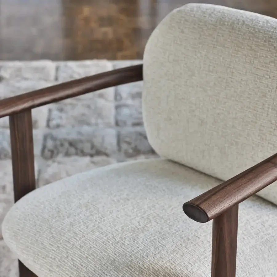 Distinguished Porada Teti chair crafted in solid wood with satin finish and off-white textured upholstery secured with saddle leather cord