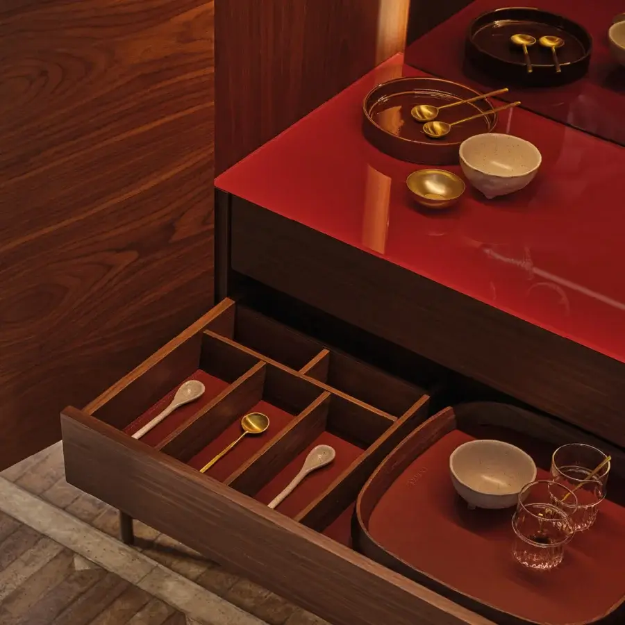 Captivating Porada Tylsa bar cabinet crafted in Canaletta walnut with satin finish and red back-painted glass, lined with Cuoietto leather