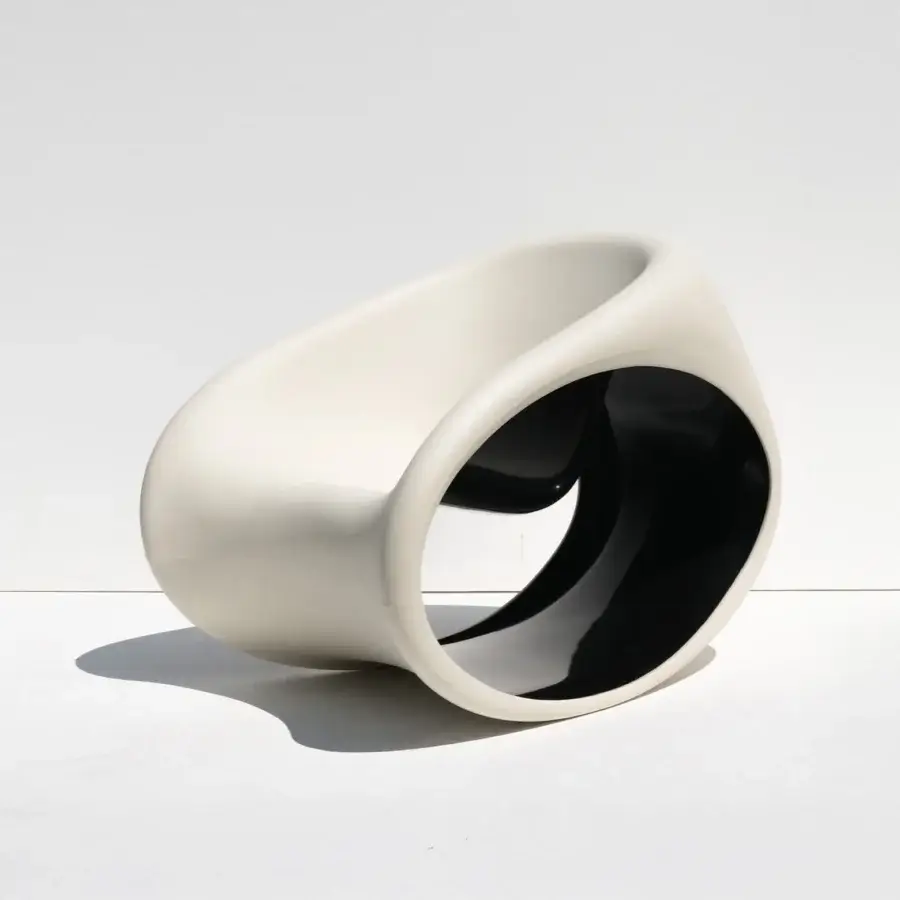 Innovative Driade MT3 rocking lounge chair with matte sand white exterior and glossy deep black interior polyethylene monoblock construction