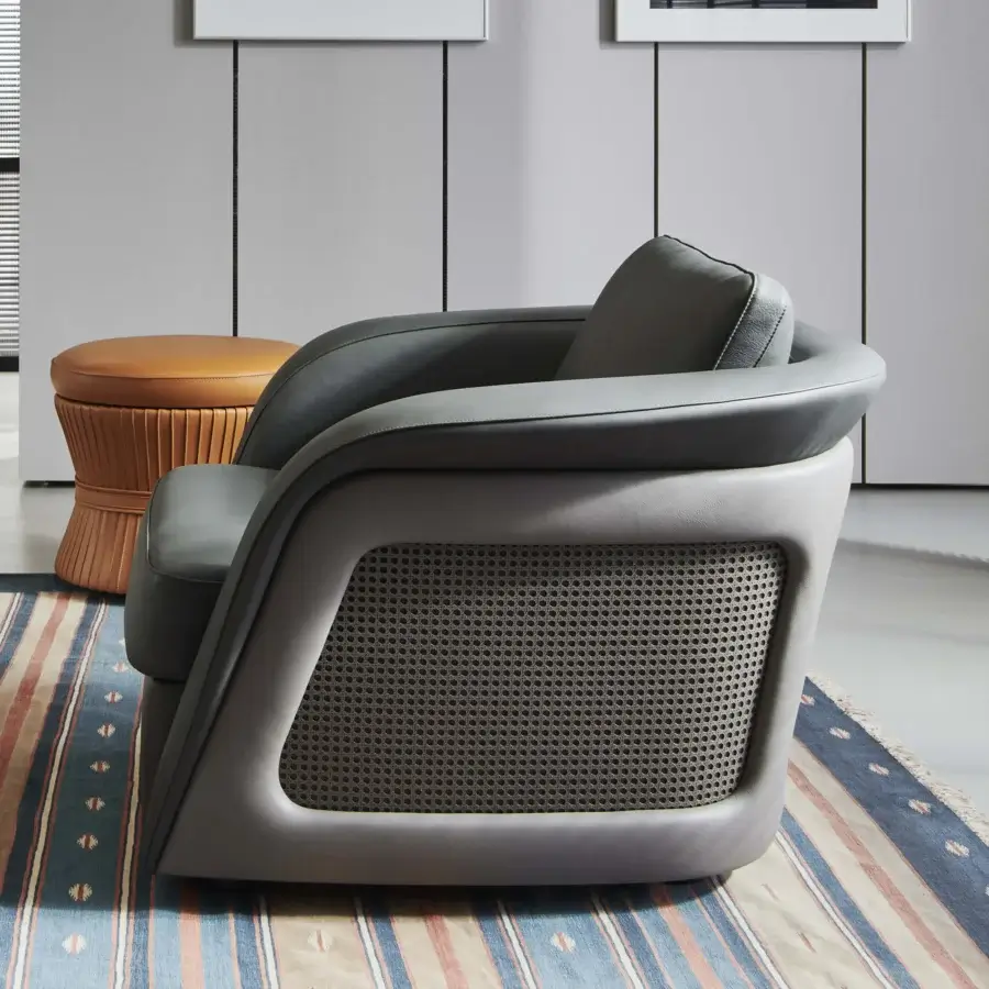 Distinguished Mascheroni Bellini Harry lounge chair with rounded form in muted gray and Vienna straw detailing crafted with perforated leather