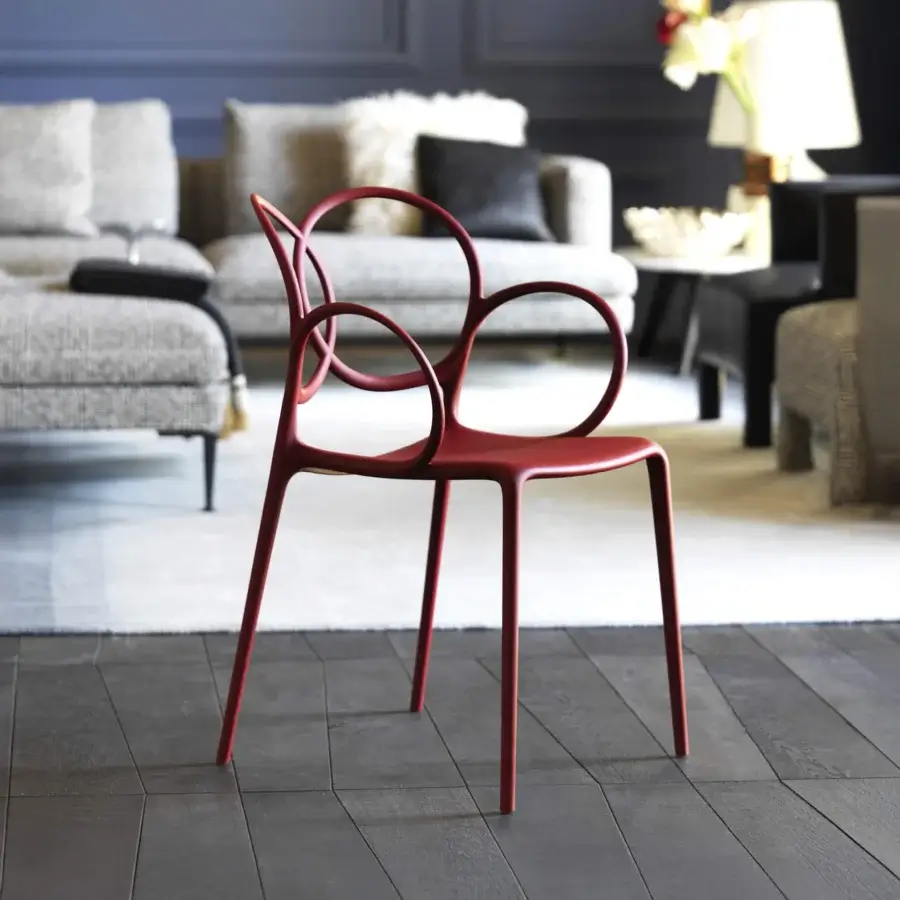 Superior Driade Sissi chair molded from durable glass fiber reinforced copolymer with glossy red finish and natural polyethylene feet