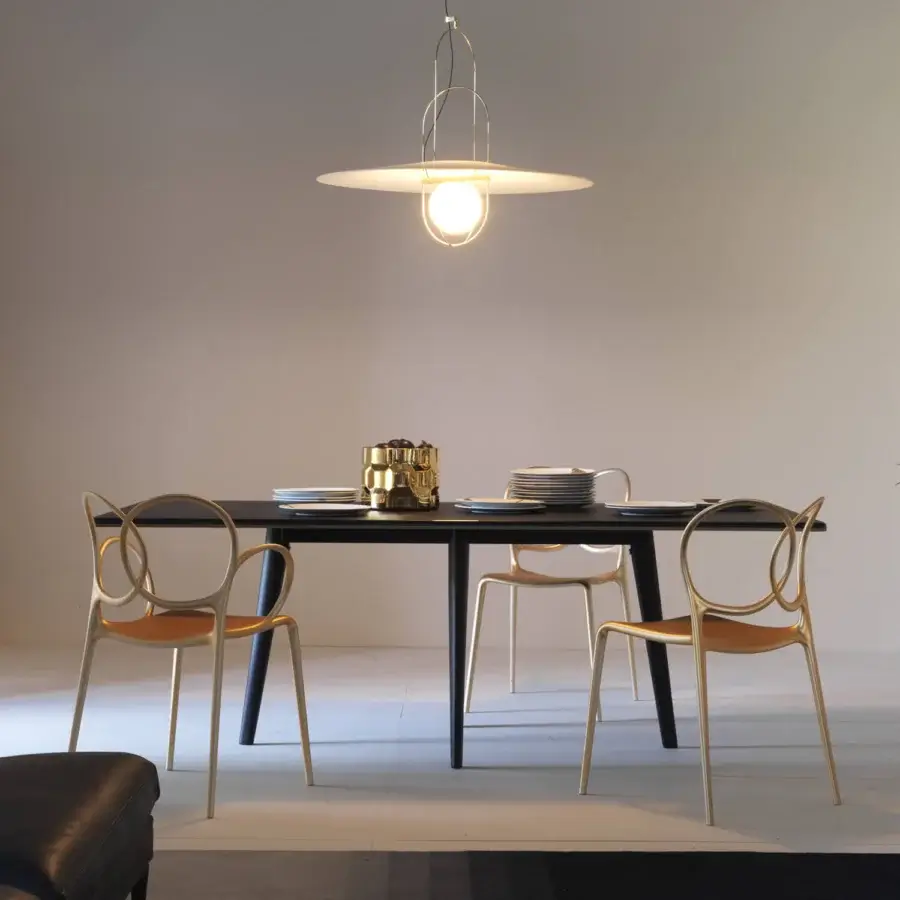 Elegant Driade Sissi chair crafted from glass fiber reinforced copolymer with a pale gold satin finish and dark brown leather cushion