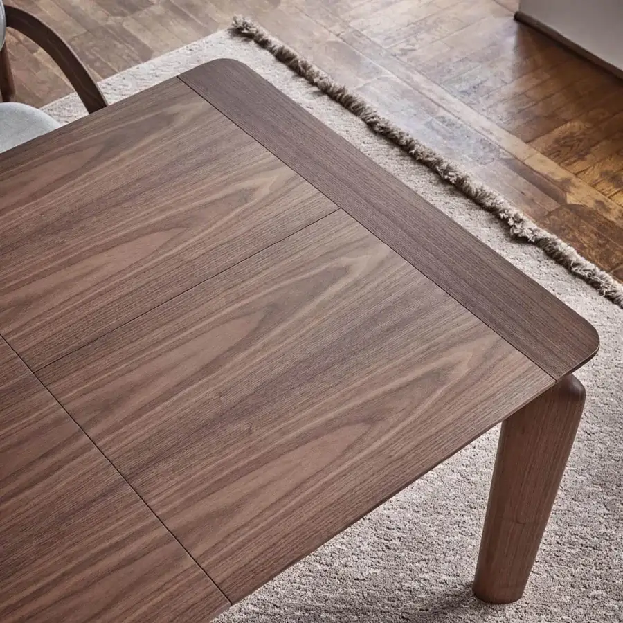 Distinguished Porada Amphora table crafted in solid Canaletta walnut with a satin finish and medium-toned brown wood grain