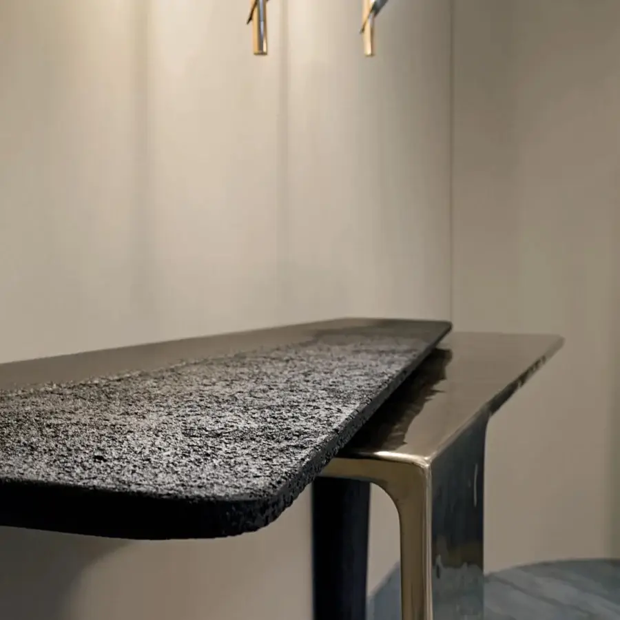 Superior Visionnaire Lego console in eroded matte black concrete and hand-polished pigmented sand-cast aluminum with undulating texture