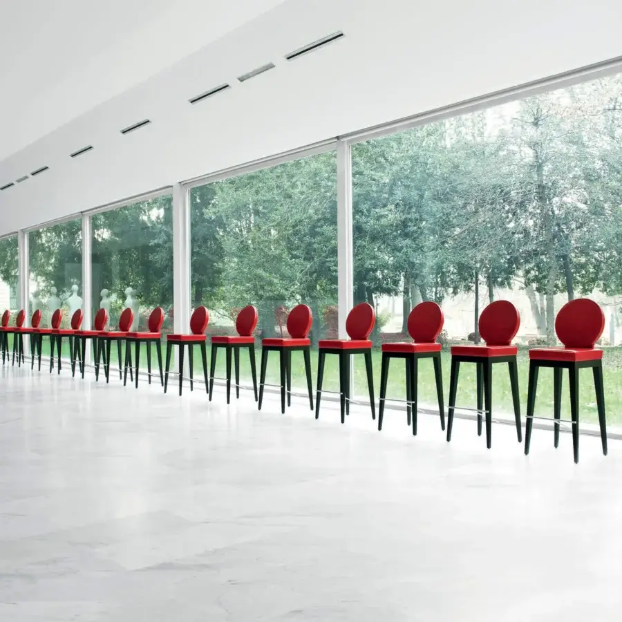 Distinguished Mascheroni Martini bar stool in red ox leather with a glossy finish and steel footrest