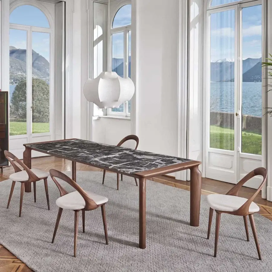 Distinguished Porada Amphora table with a striking marble tabletop and solid Canaletta walnut legs in a satin finish